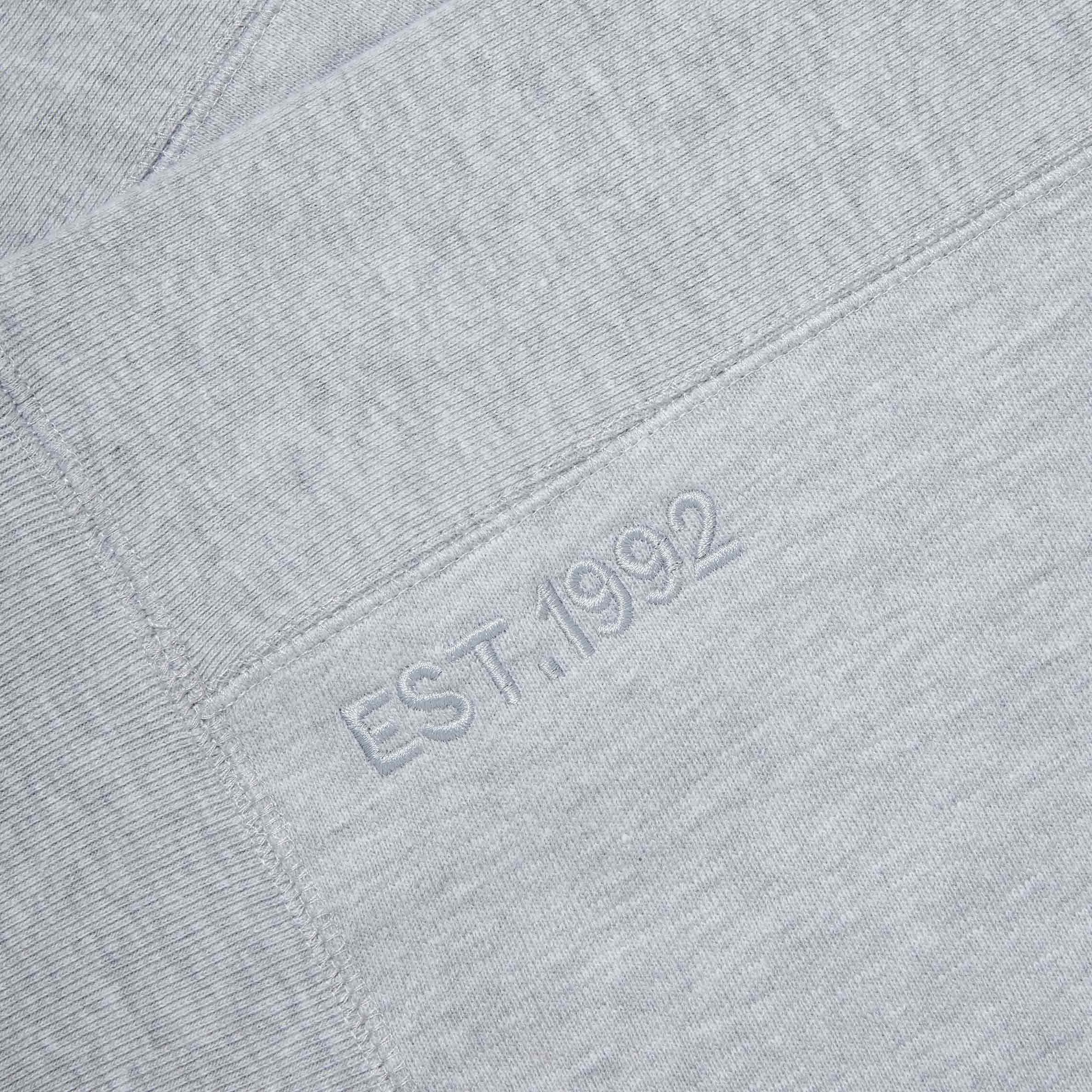 Close-up of ‘EST. 1992’ embroidery on Lanzera Club Crewneck sweatshirt in Grey Heather.