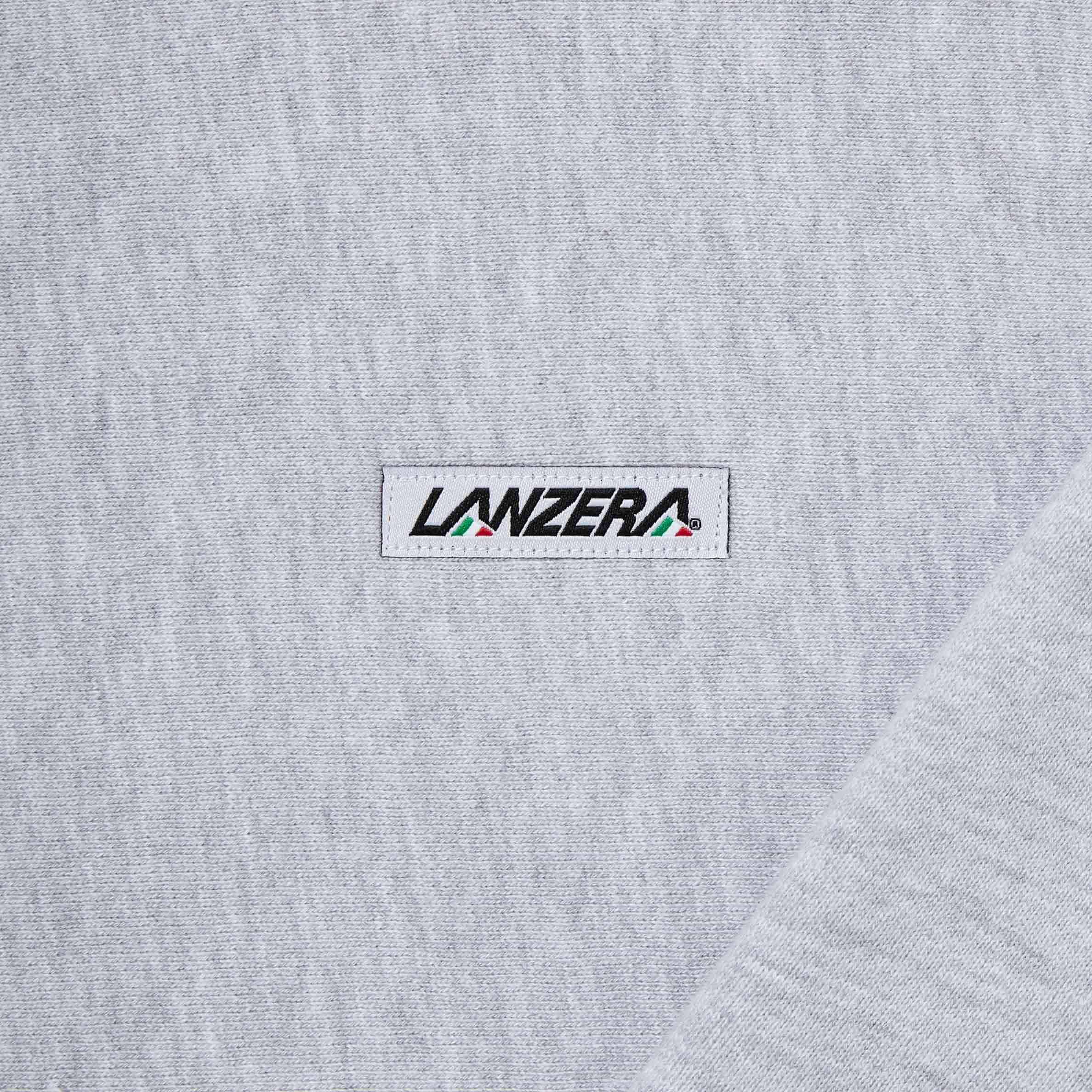 Close-up of Lanzera logo patch on Club Crewneck sweatshirt in Grey Heather.
