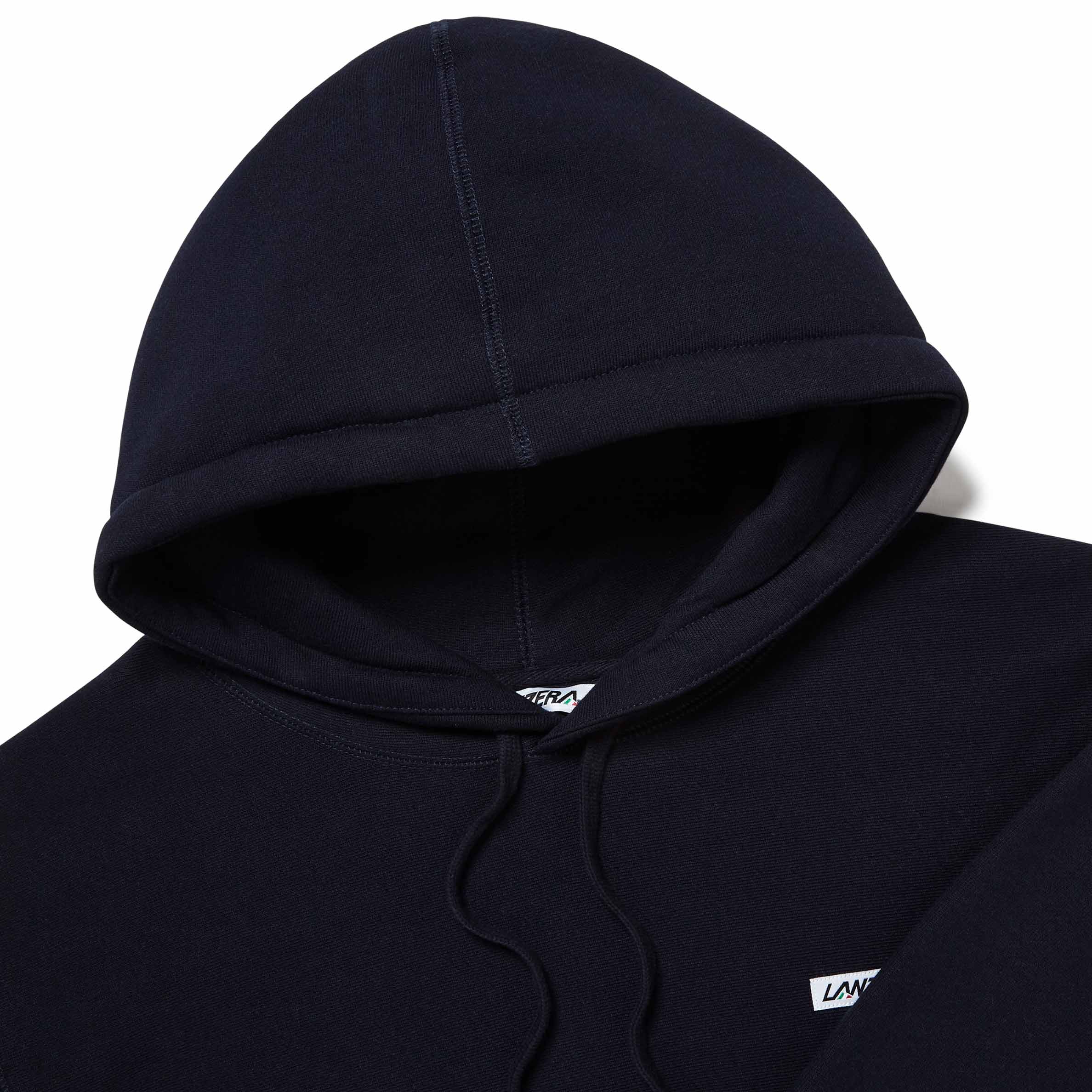 Close-up of logo patch, hood, and fabric on Lanzera Club Hoodie in Navy Clásico.