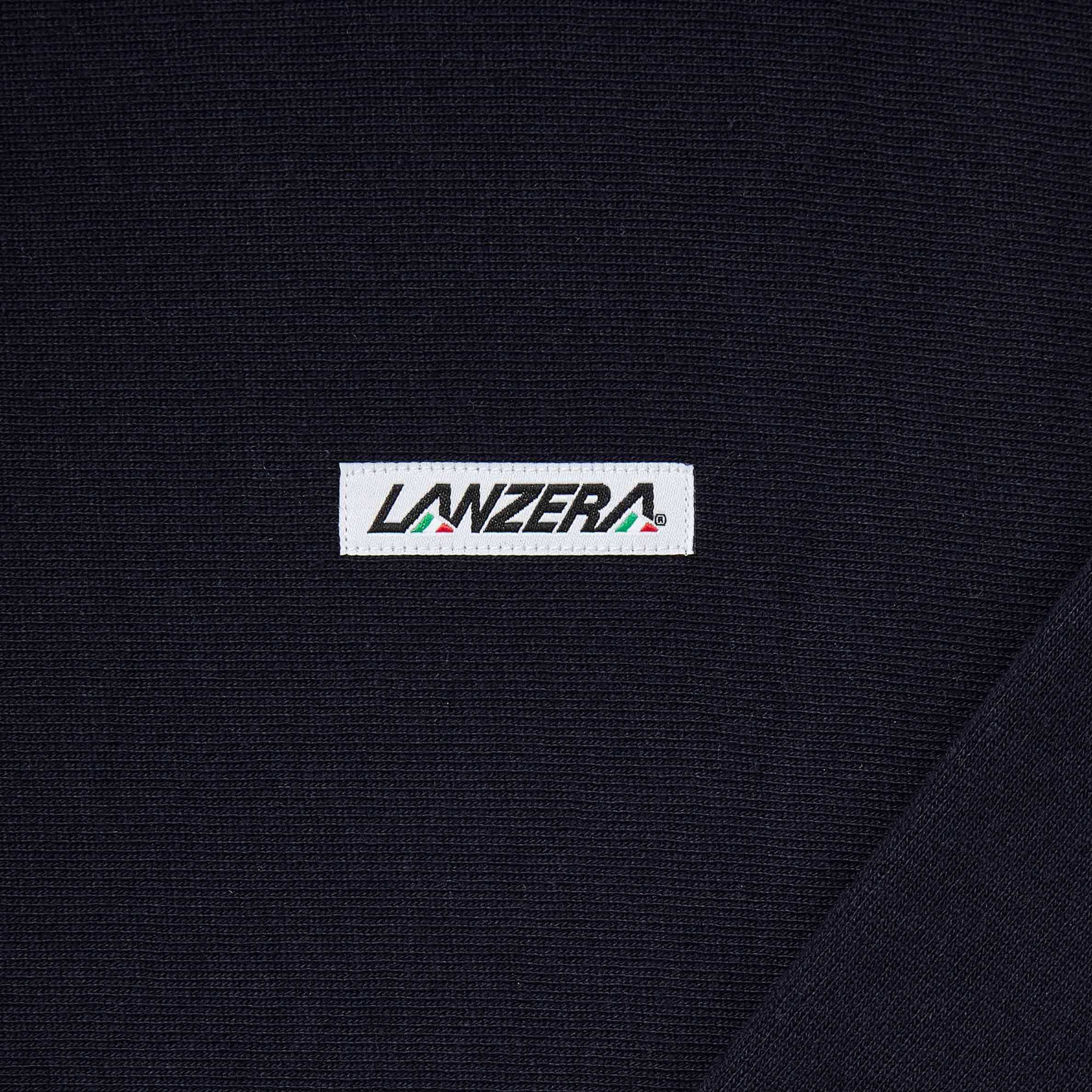 Close-up of embroidered logo patch on Lanzera Club Hoodie in Navy Clásico.