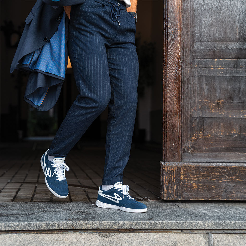 A person wearing Lanzera Jackal Navy suede sneakers with a tailored outfit, showcasing the versatility of the shoe for both casual and refined streetwear aesthetics.