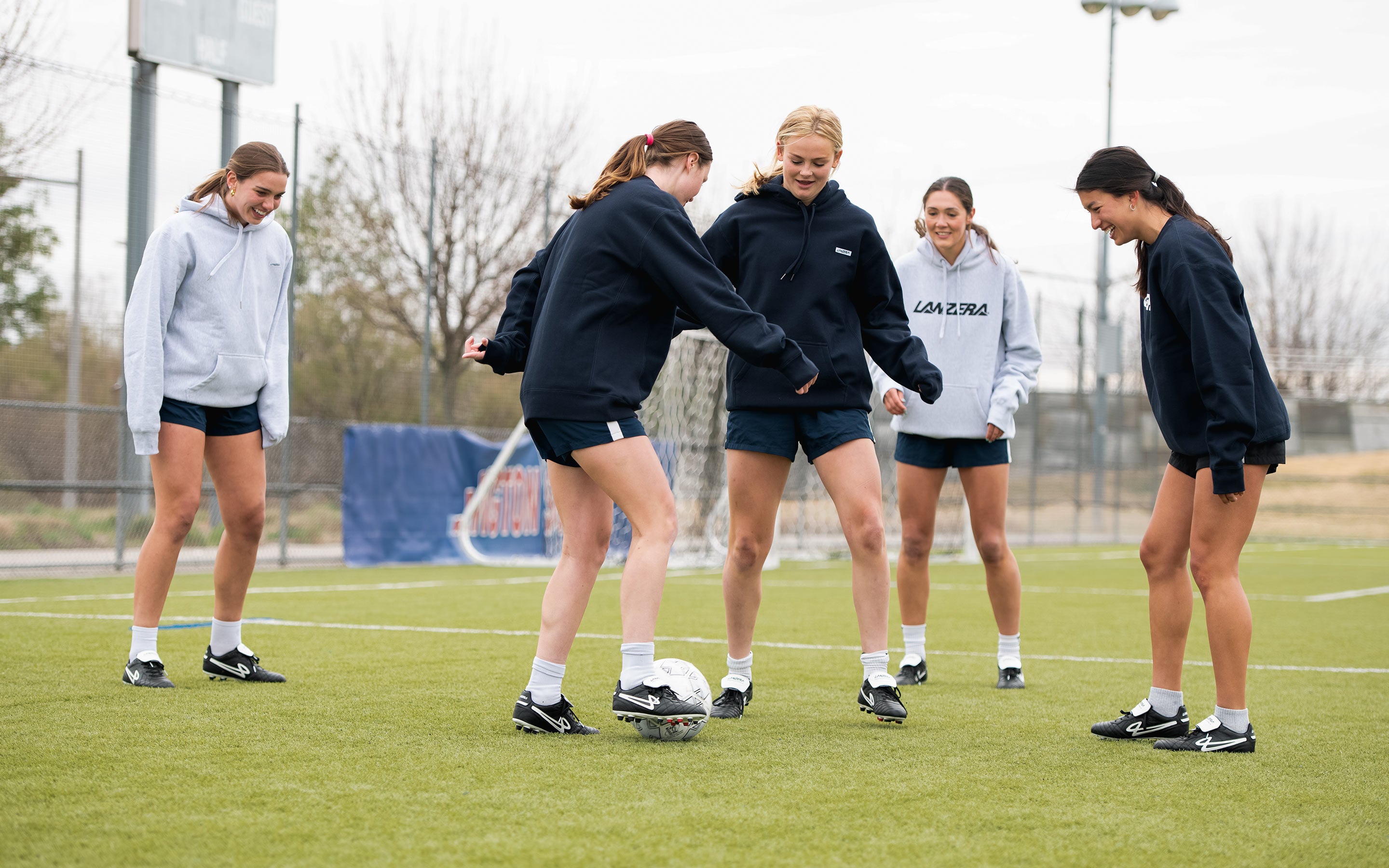 Group of footballers playing rondo wearing Lanzera Professionale cleats and apparel.
